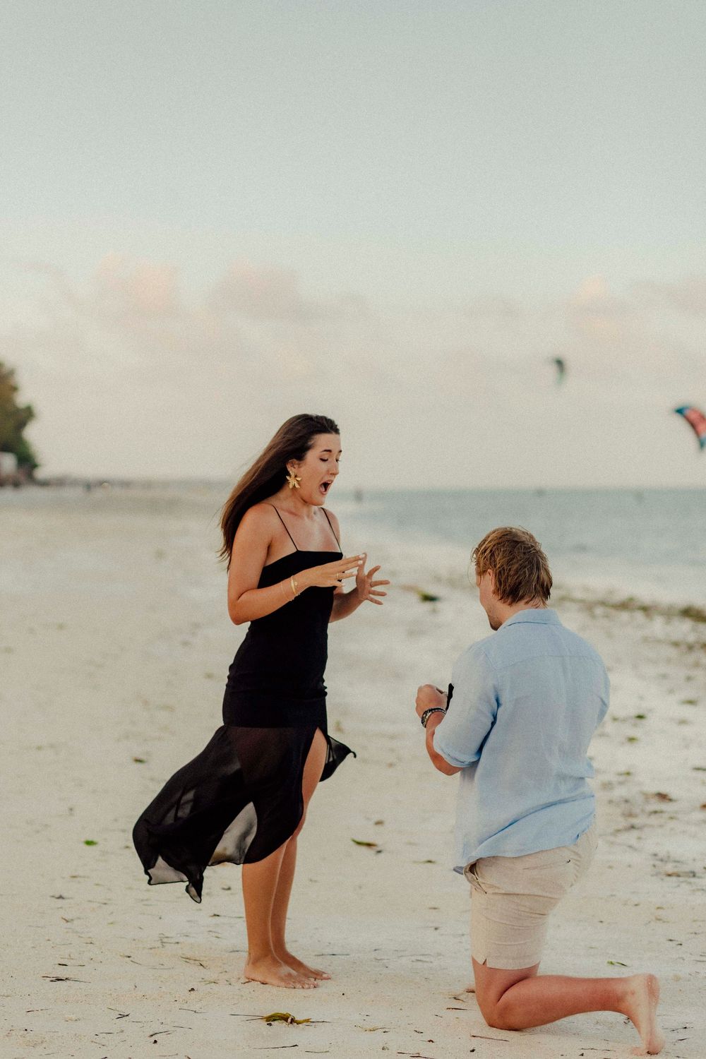Couple laughing together during beach photoshoot.