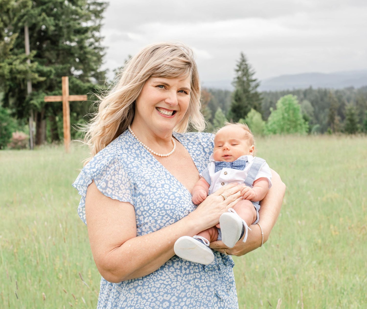 A series of outdoor family photos in a grassy field with evergreen trees in the background.