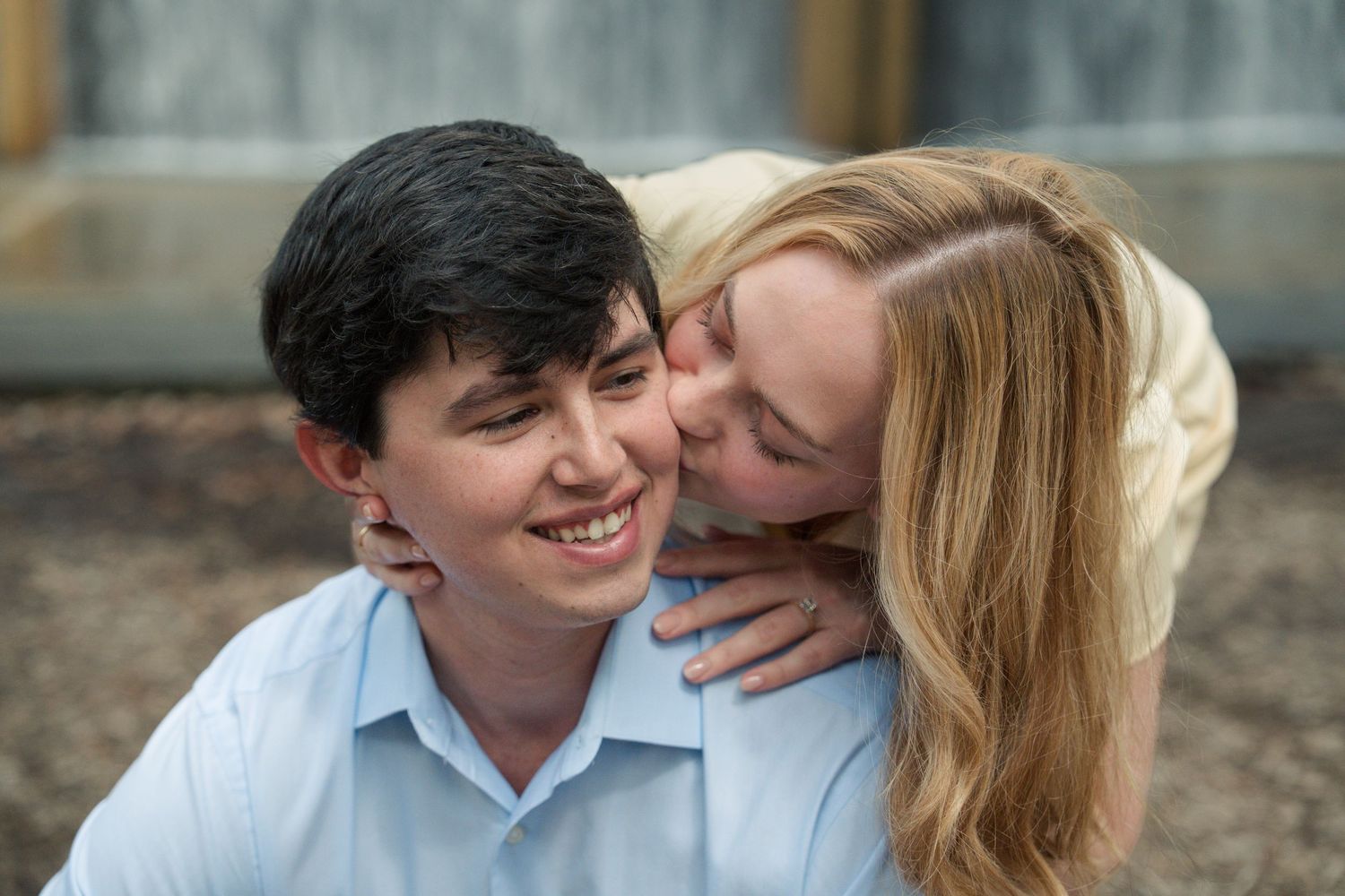 A romantic couple shares tender moments during an outdoor engagement photoshoot.