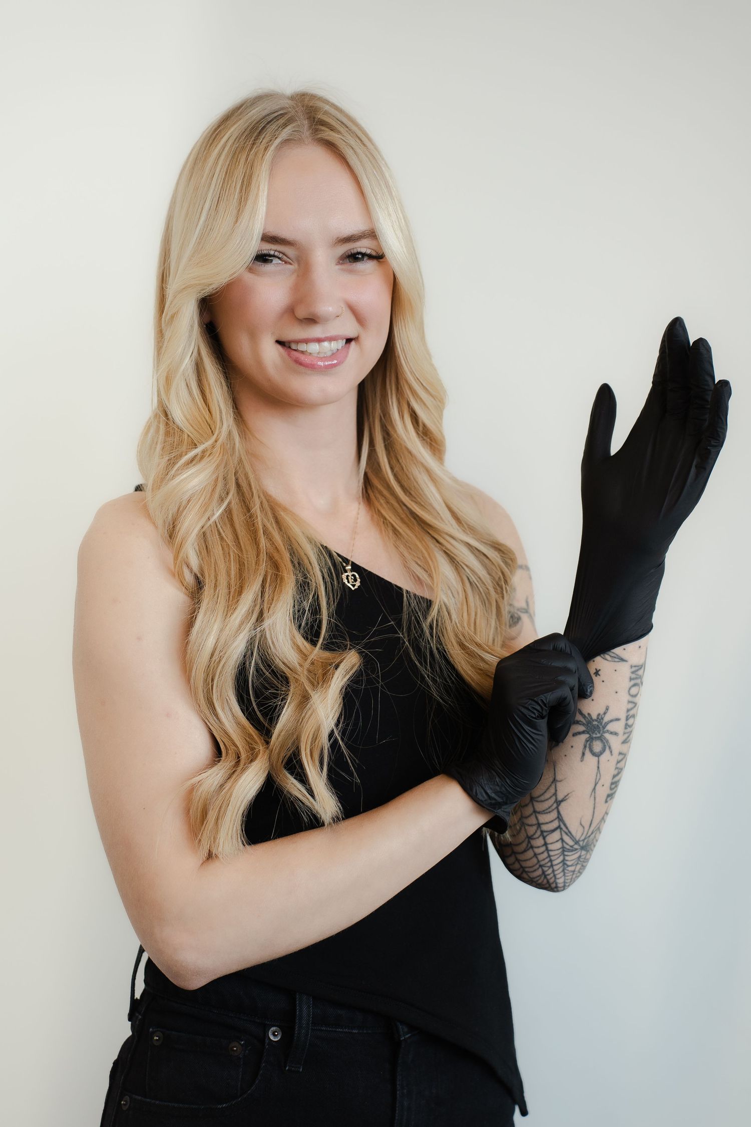 Four sequential photos show a person in a black top and gloves posing playfully against a white background.