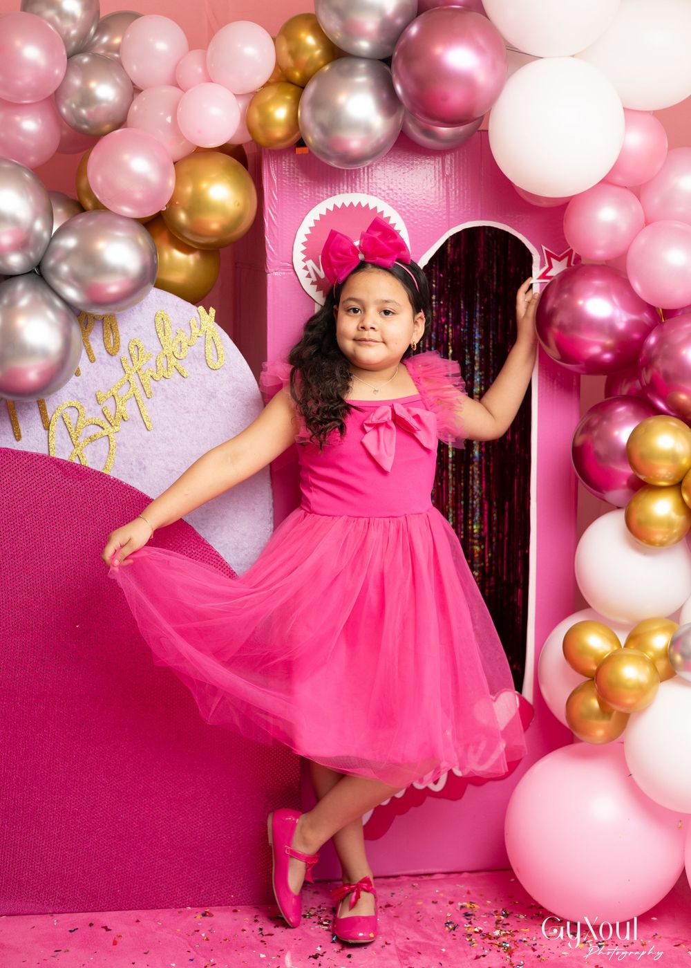 Whimsical pink party scene with balloon garland and gold accents creating a magical celebration atmosphere.