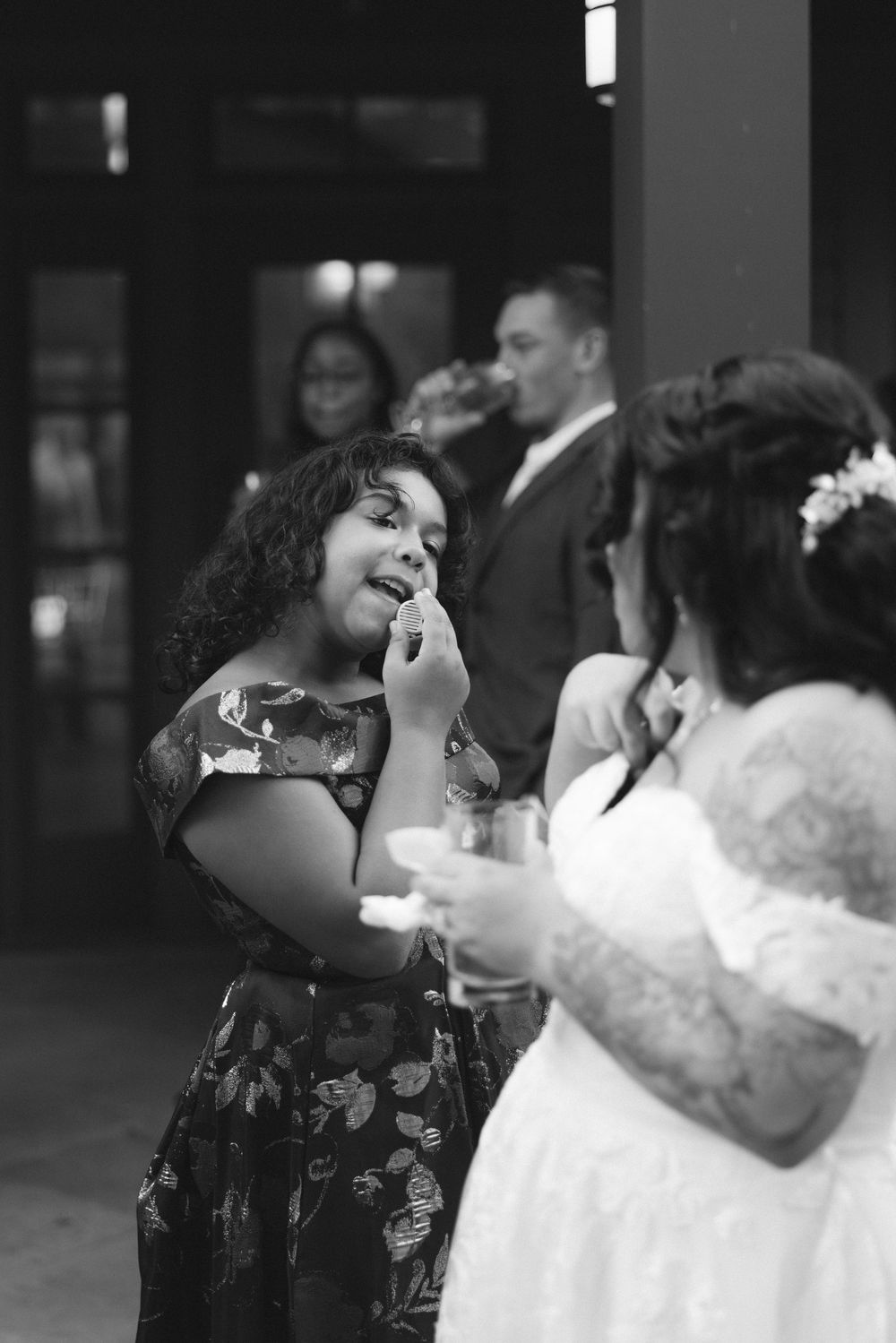 A couple shares a romantic dance together in black and white at an evening event.