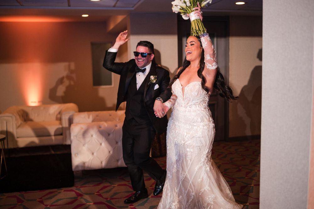 Bride celebrating with groom on dance floor during wedding reception at Royal Sonesta Puerto Rico