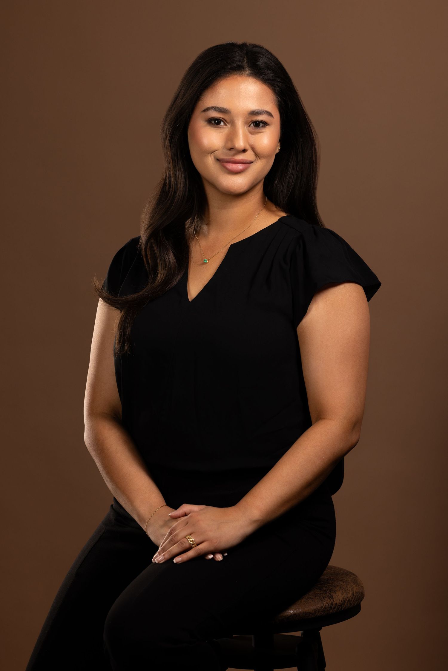 Professional portrait series showing a person in a black top against a brown backdrop in various elegant poses.
