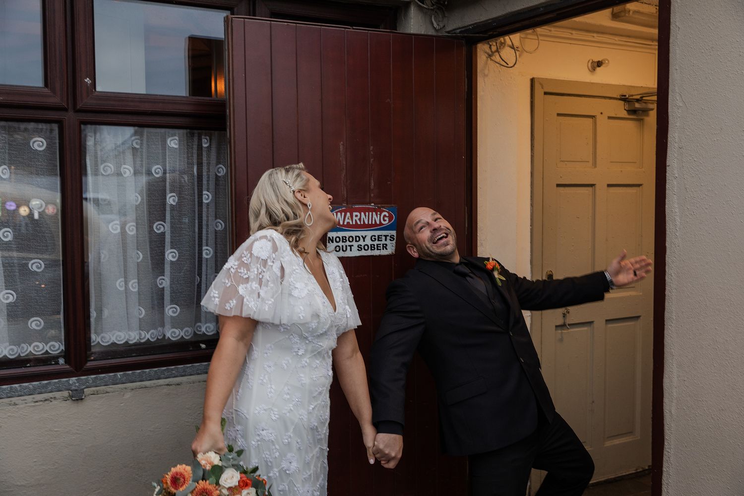 Newlyweds celebrating with Guinness in a Doolin pub.