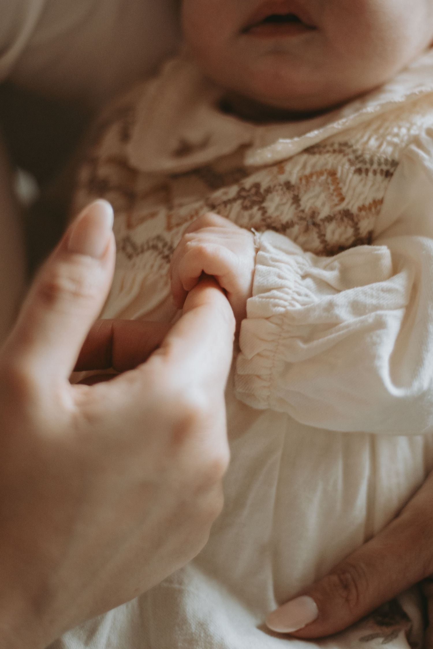 Delicate close-up shots of hands touching white lace fabric details.