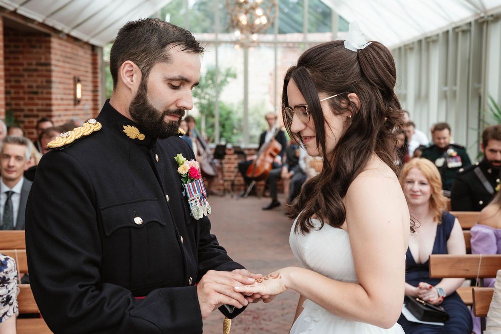 Syrencot House wedding venue Wiltshire Georgian manor couple exchanging rings inside glasshouse