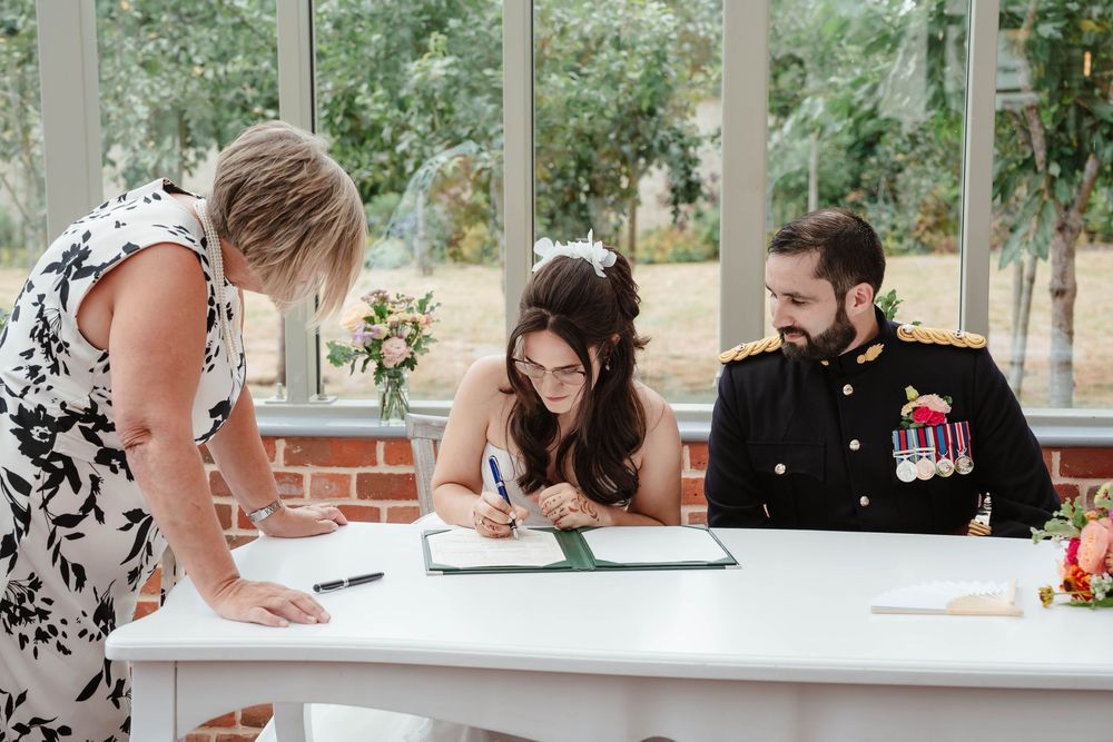 Syrencot House wedding venue Wiltshire Georgian manor couple signing the registrar