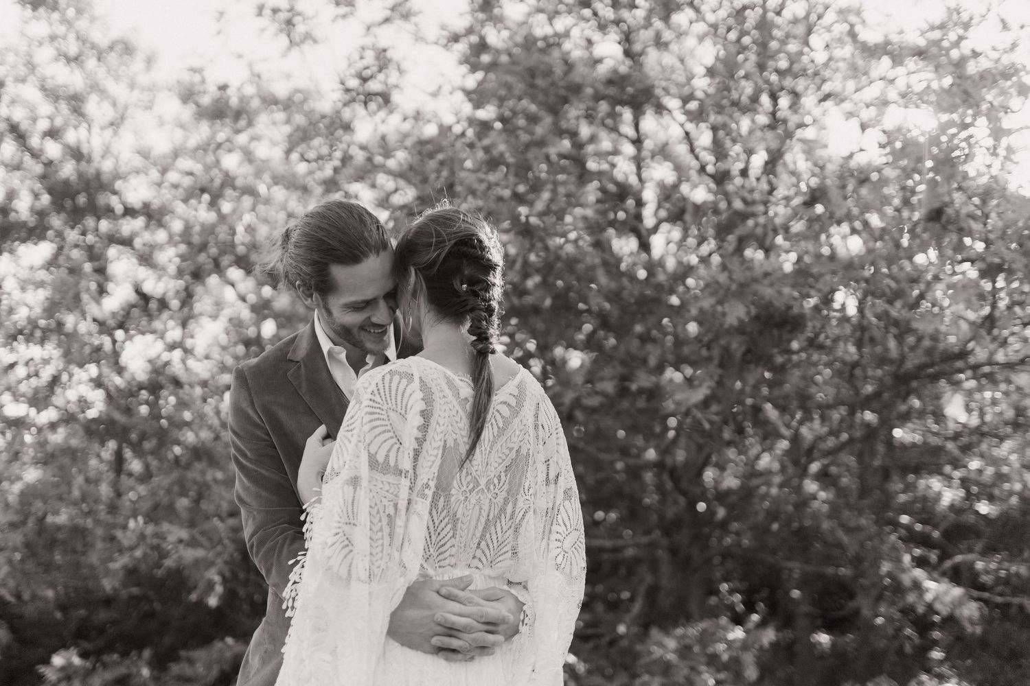 A series of black and white romantic photographs showing intimate moments between a couple in an outdoor setting.