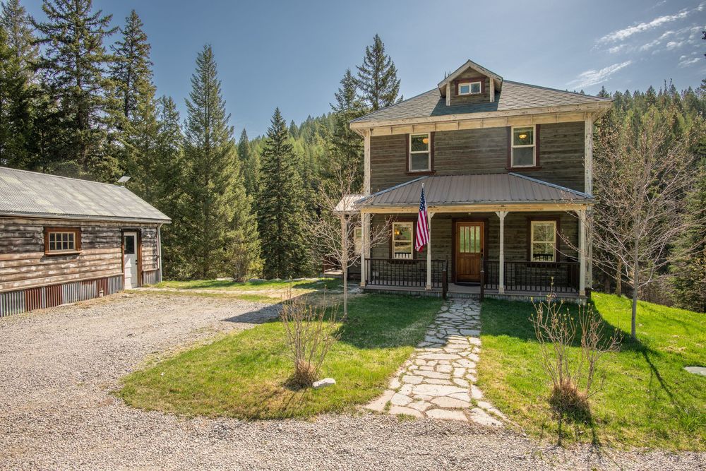 A rustic mountain cabin with multiple exterior views showcasing its natural wood siding and gravel driveway.
