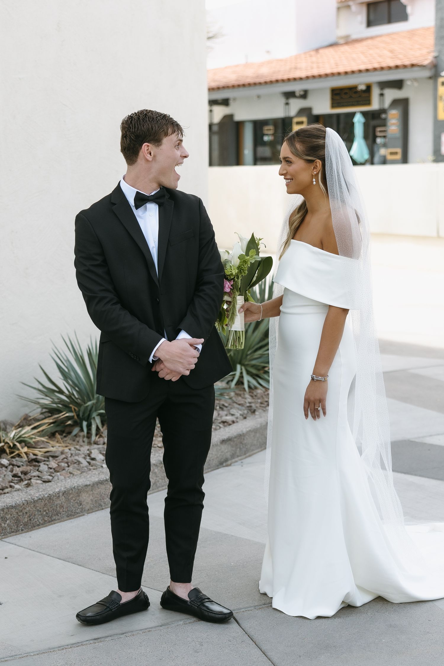 Joyful couple sharing a moment during their wedding photoshoot.