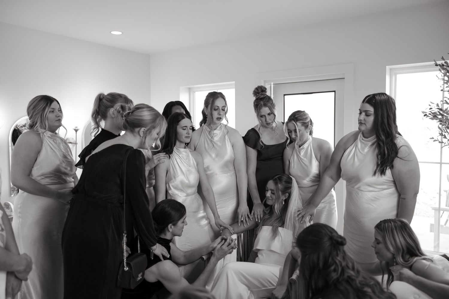 Wedding preparation moment in a bright white room.