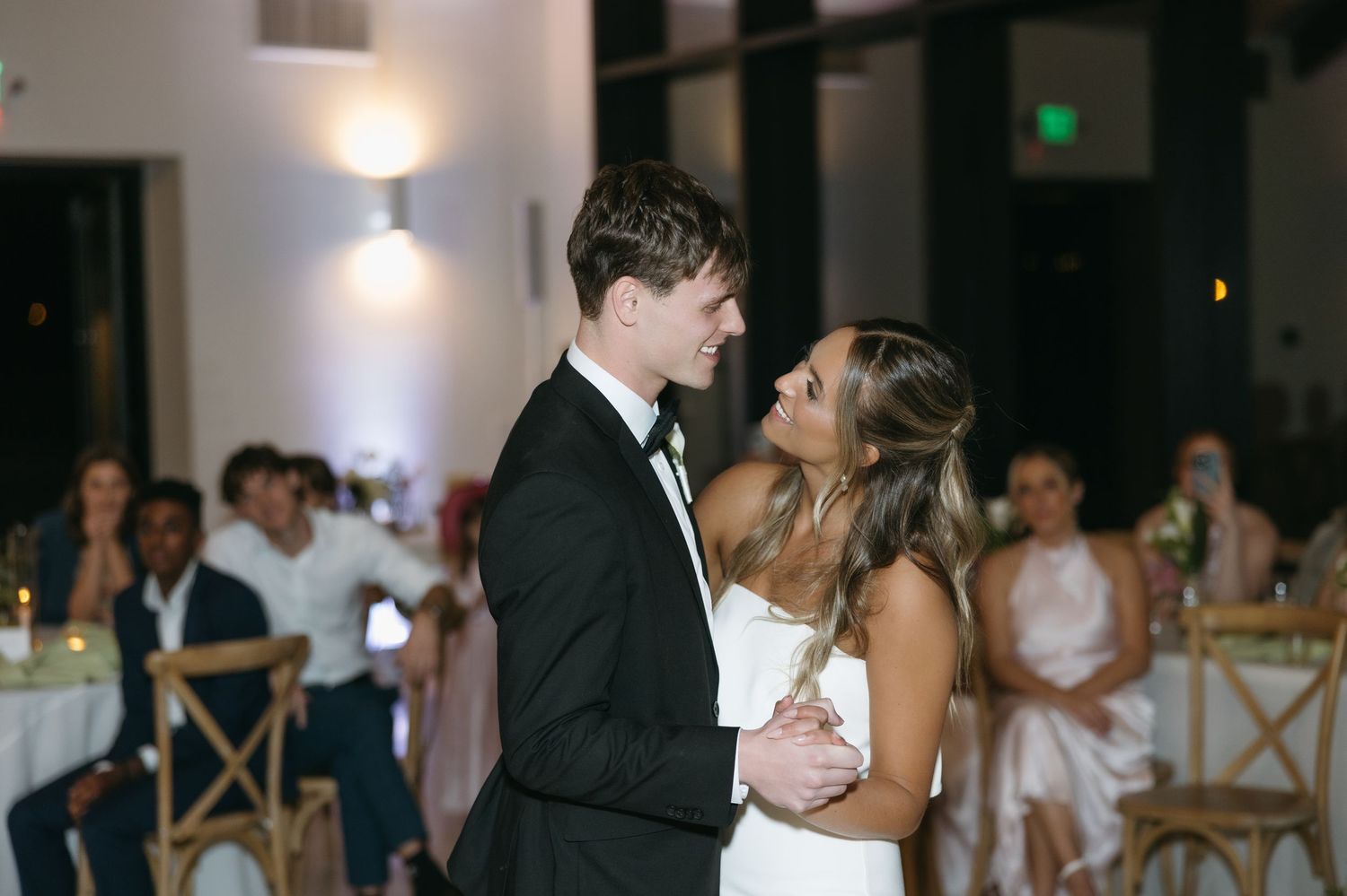 A newlywed couple sharing their first dance at their wedding reception.