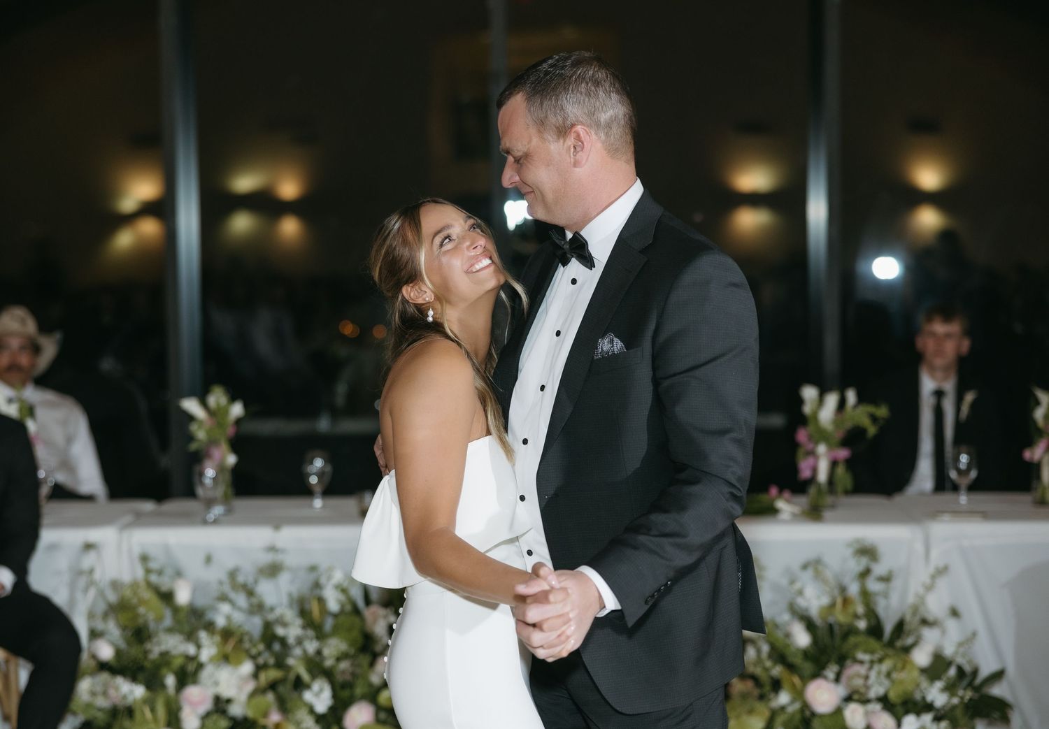 A couple shares an intimate dance moment at their wedding reception.