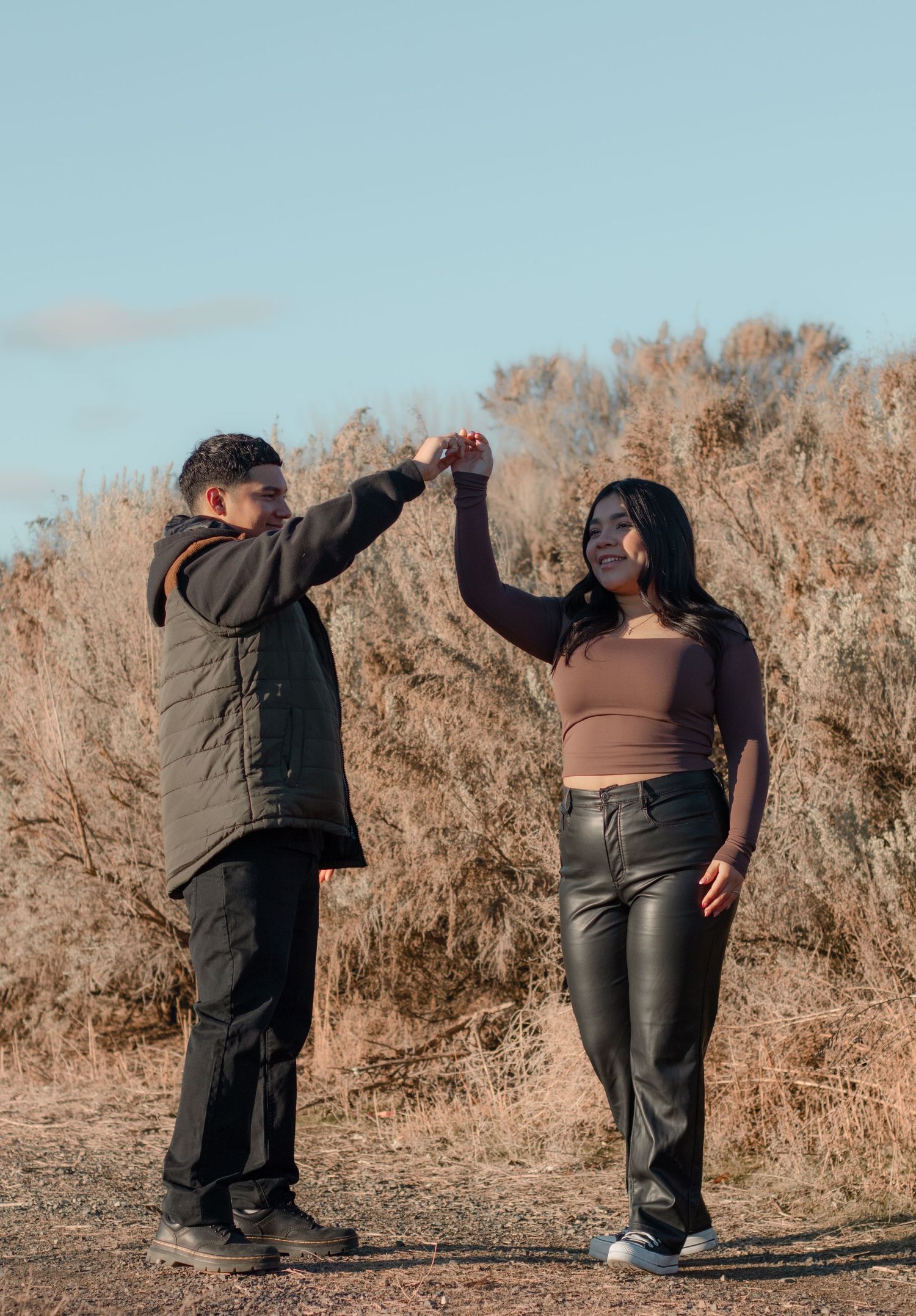 Playful couples photo of man twirling his partner during sunset session in Eastern Washington
