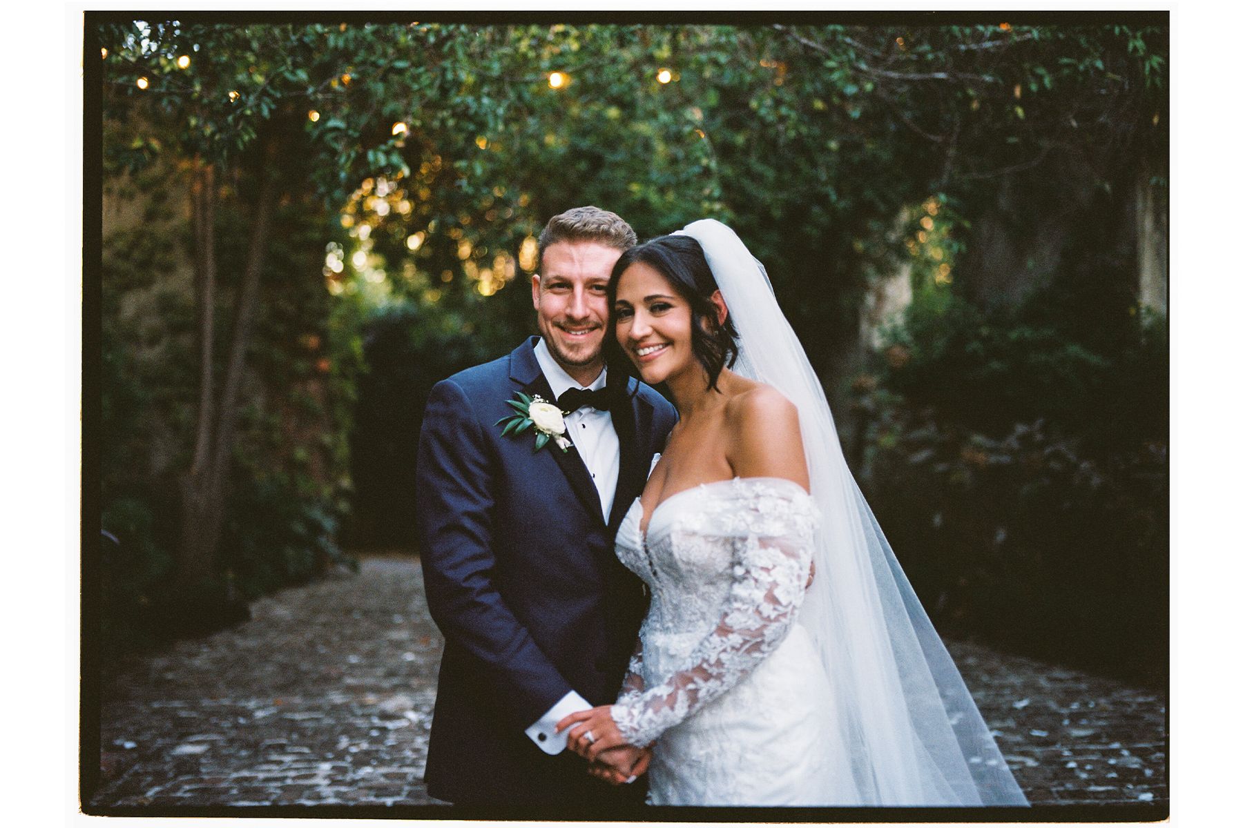 A romantic outdoor wedding ceremony setup with natural greenery and soft lighting.