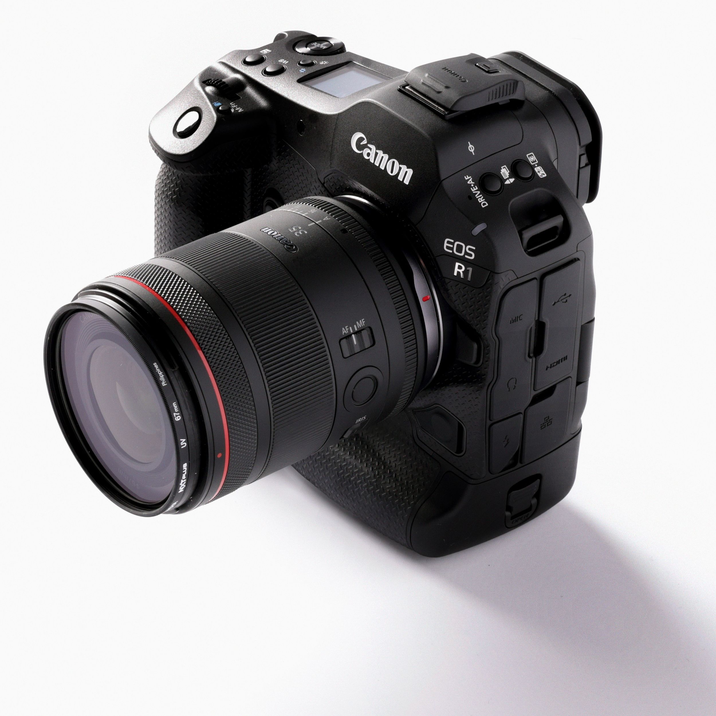 Canon EOS R1 camera with lens photographed on a white studio background.