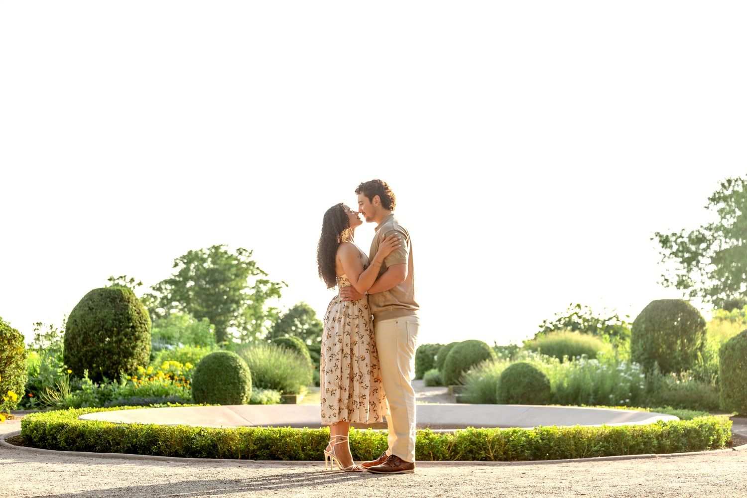 Couple lying on grass during fall engagement photo session.