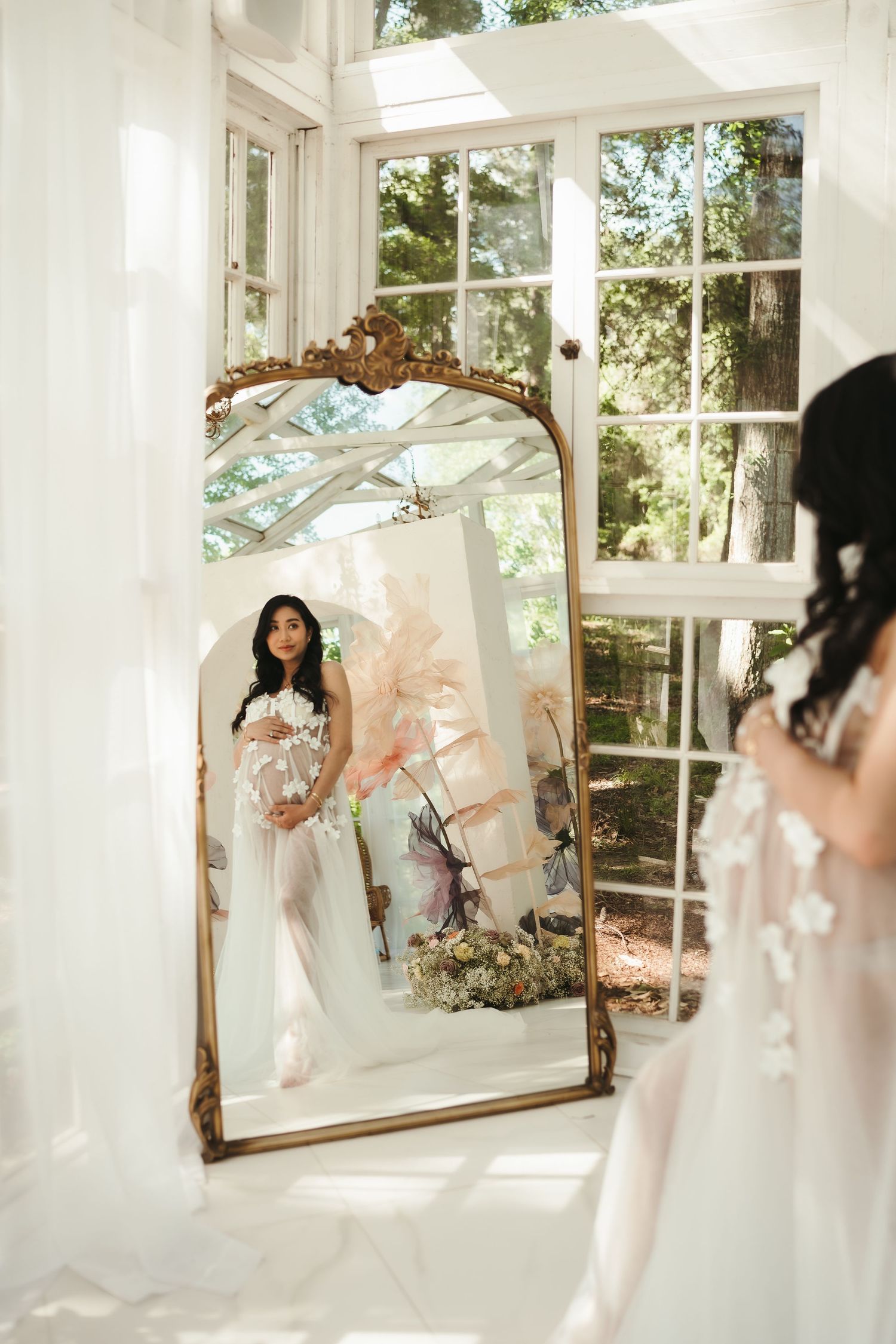 Dreamy mirror reflection photoshoot in bright sunlit conservatory.