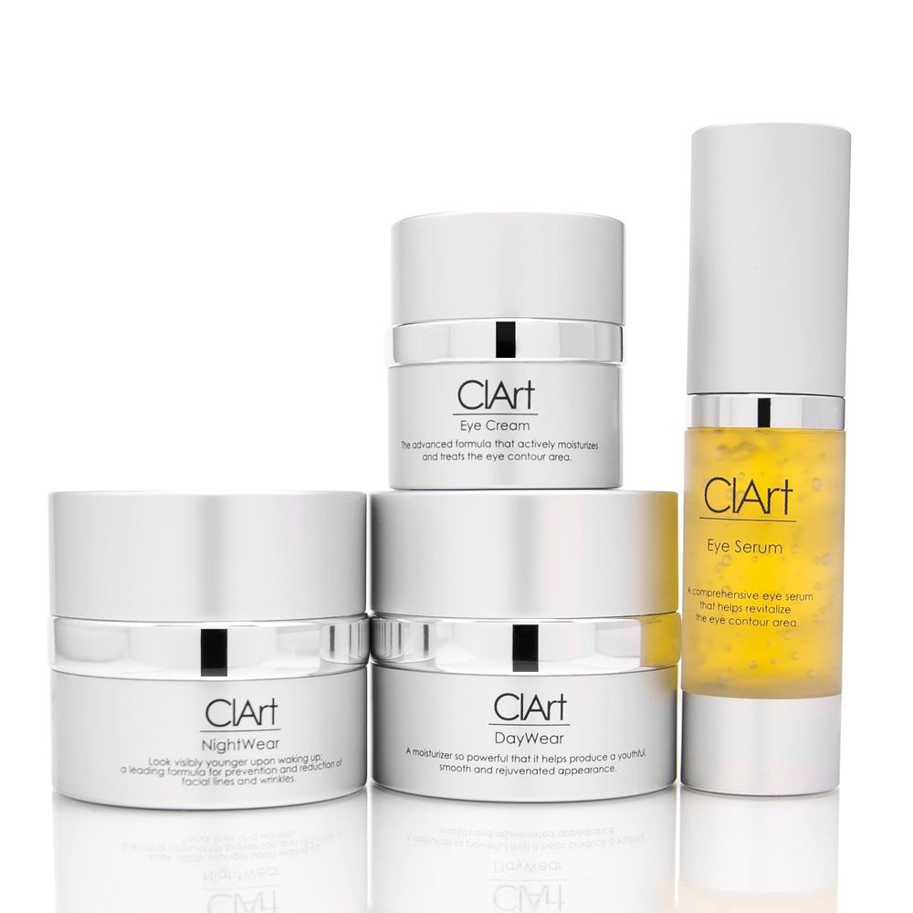 Collection of white luxury skincare products including serums and creams from ClArt beauty line arranged on white background.