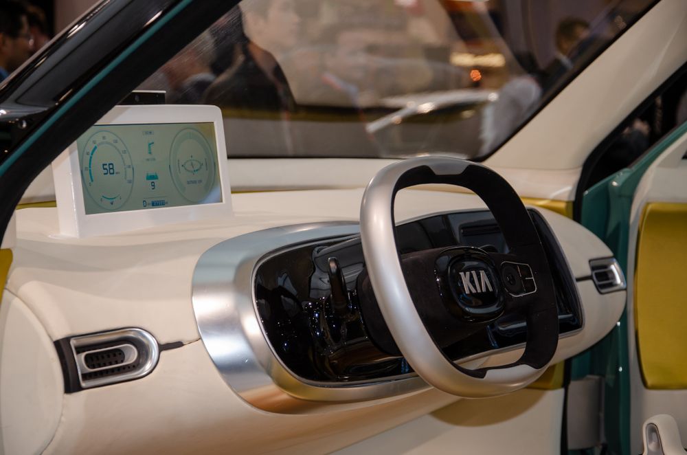 Interior view of modern car dashboard and steering wheel controls.