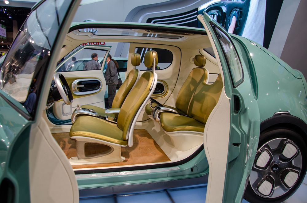 Display of luxury vehicle interior with beige leather seats and modern dashboard design.