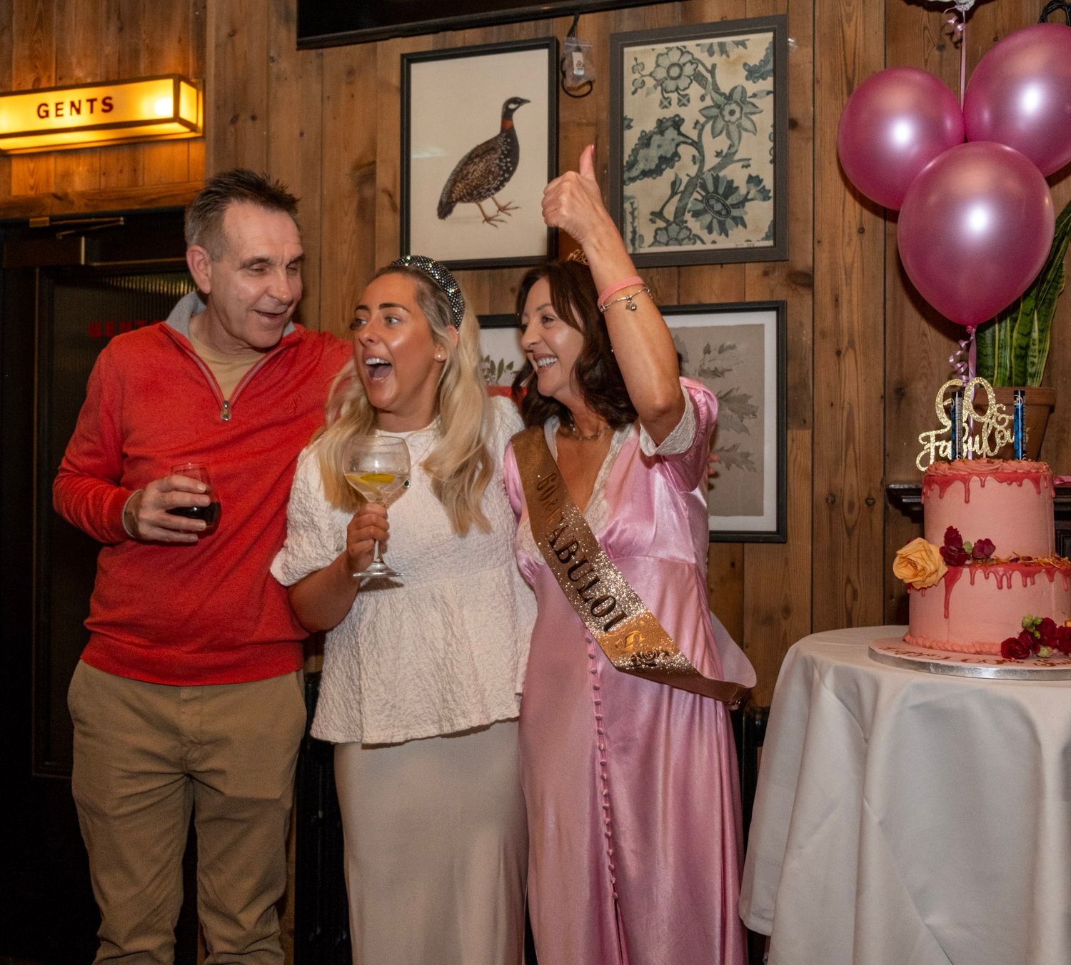 Party celebration with pink balloons and decorative wall art featuring birds in a cozy restaurant setting.
Dublin, Ireland.