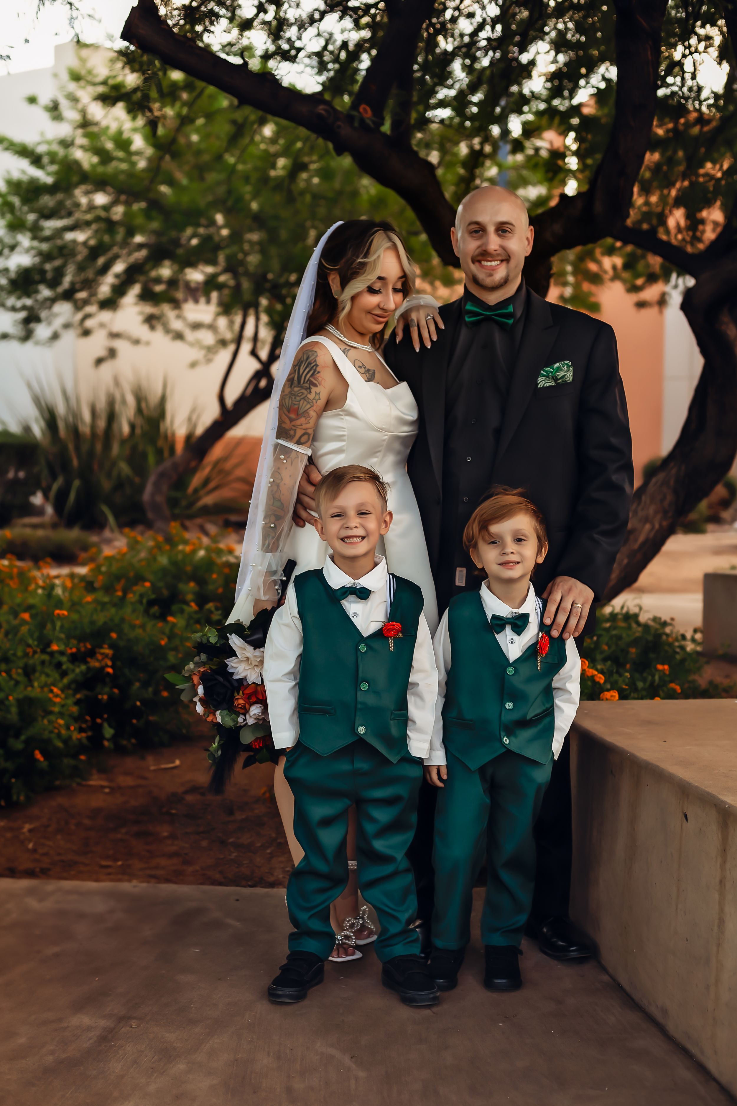 A family wedding portrait with matching green vests after their courthouse wedding in Phoenix Arizona