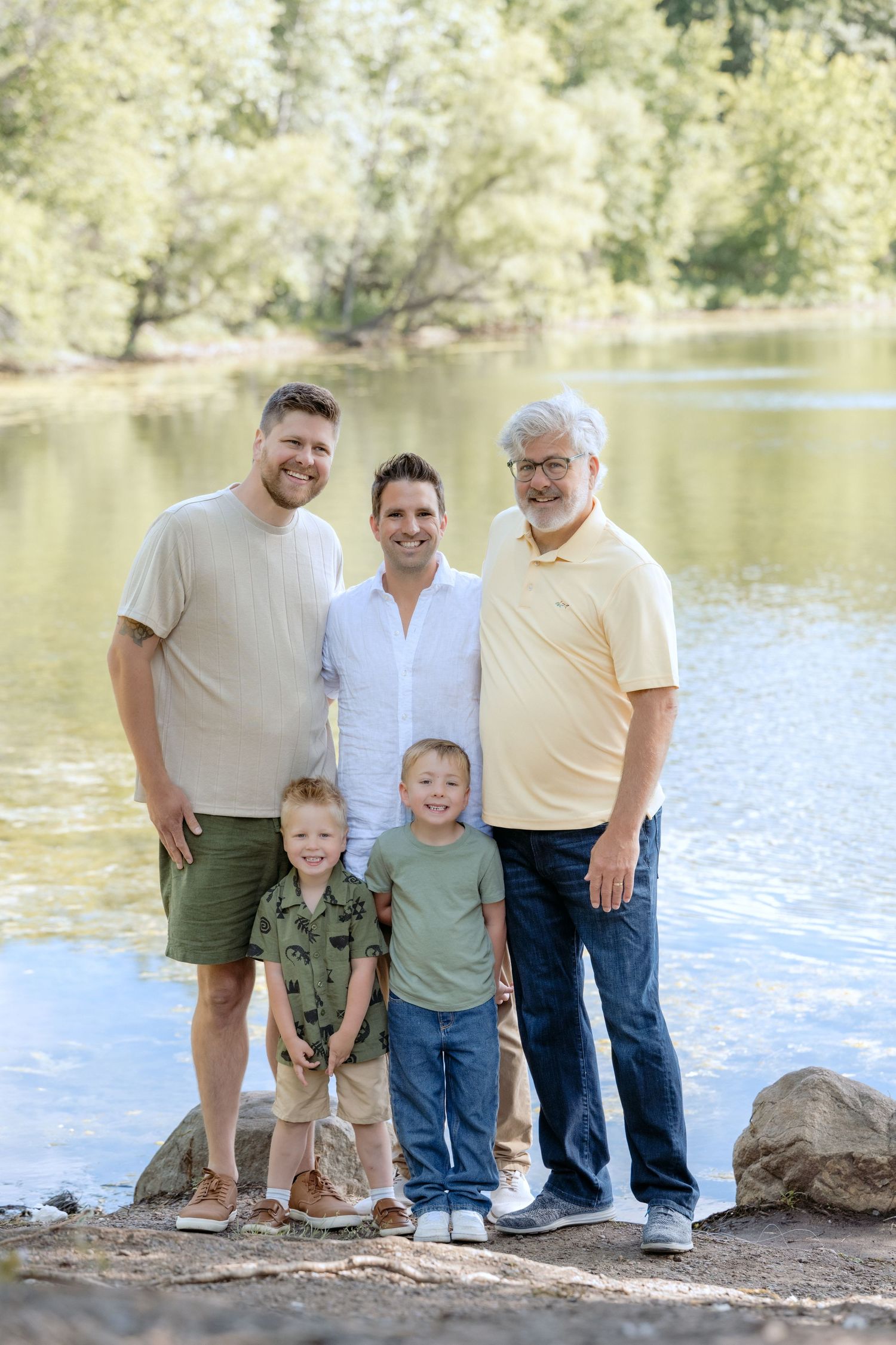 portrait of all the boys by the water during extended family portrait session at powers lake park in woodbury mn