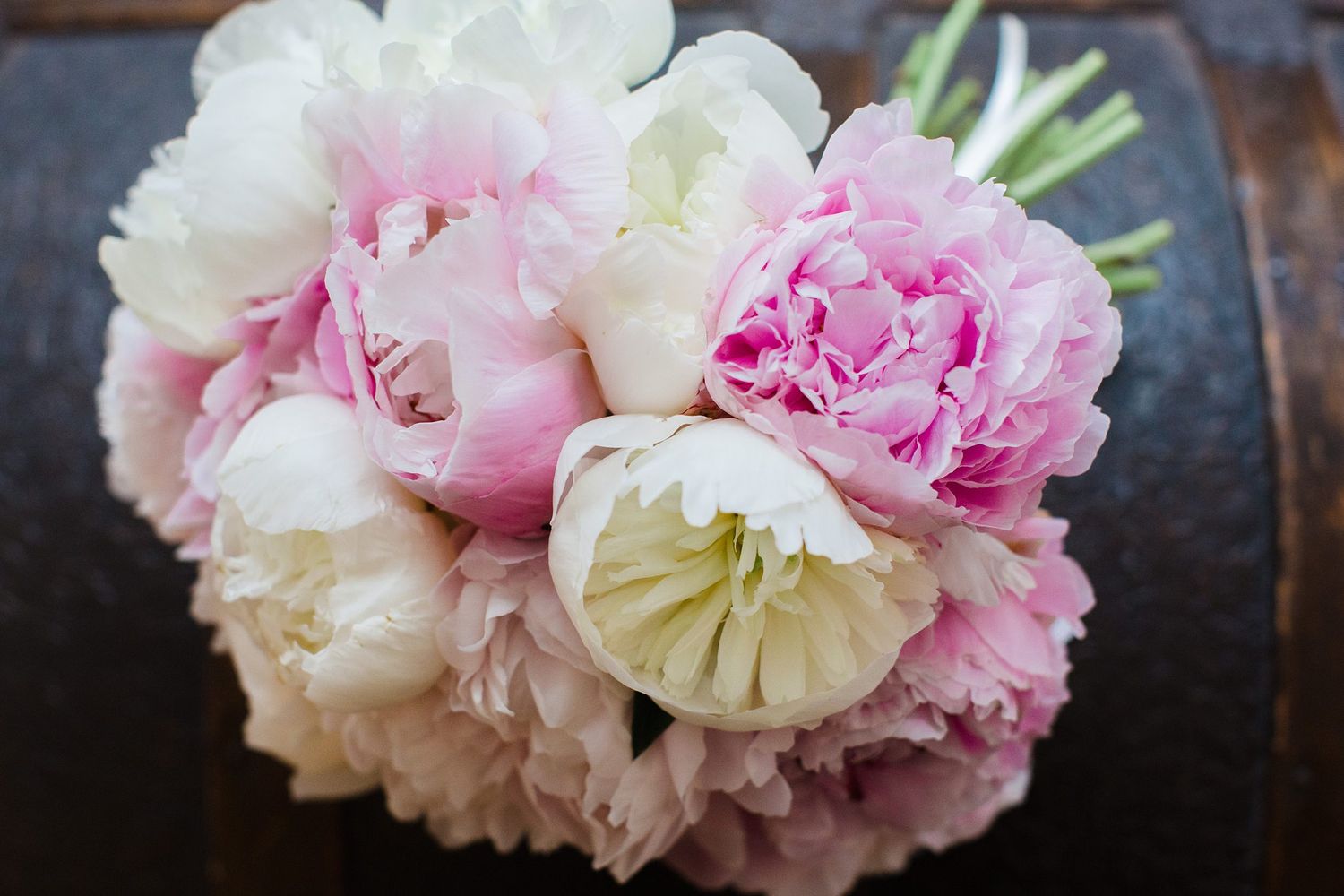 A beautiful bouquet of pink and white peony flowers arranged together, perfect for weddings or special occasions.