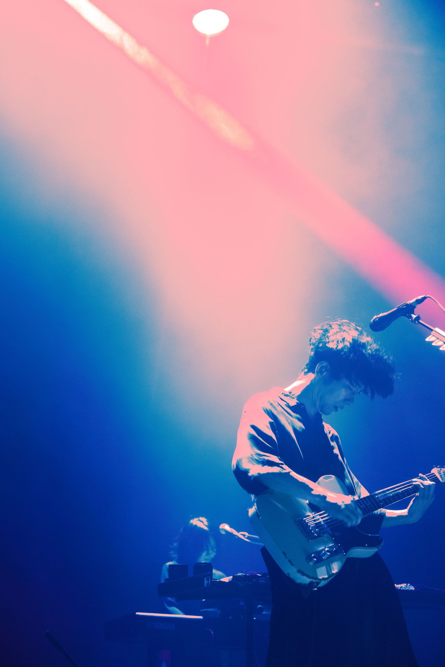 A concert photo of TK from Ling Tosite Sigure under red concert lights. A concert photo taken at the Belasco in LA by mwendwa on May 29.