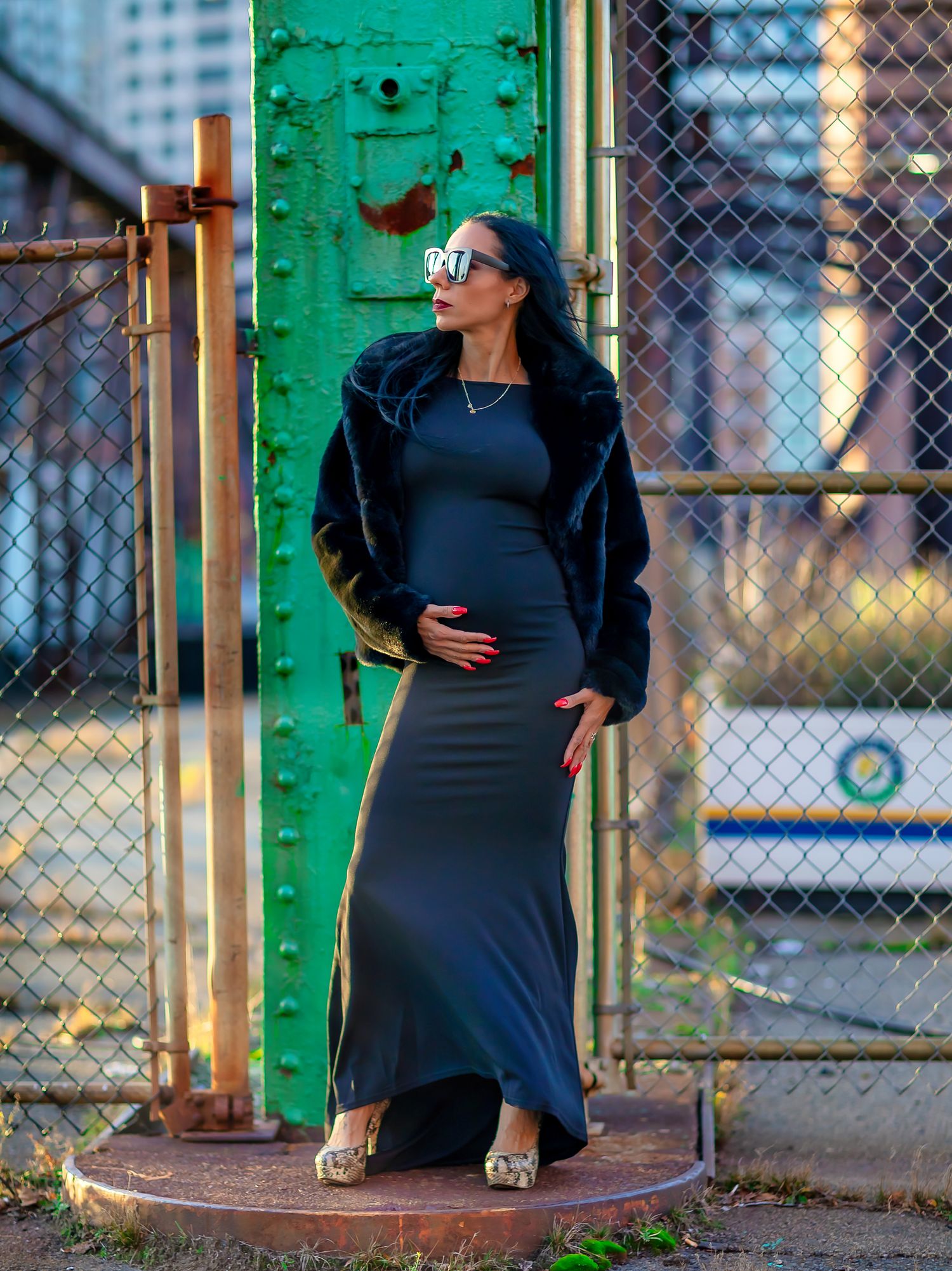 A series of outdoor portraits showing a person in a black dress posing against a green industrial backdrop.