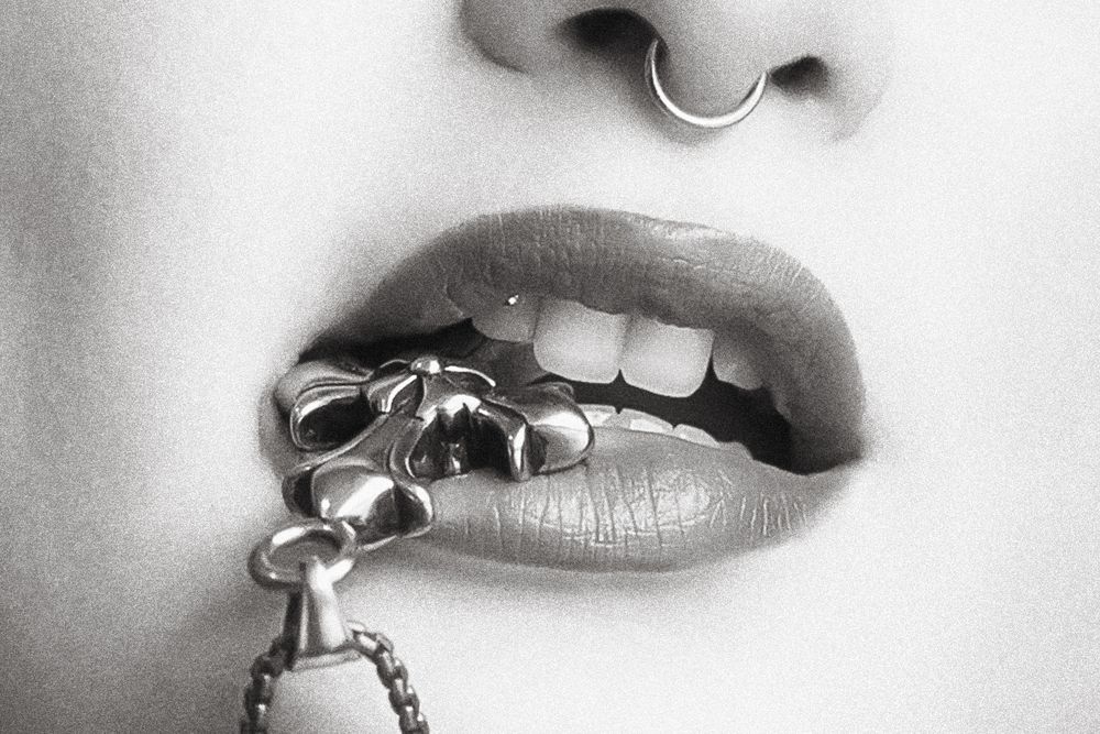 Closeup of woman biting cross necklace harm in Miami