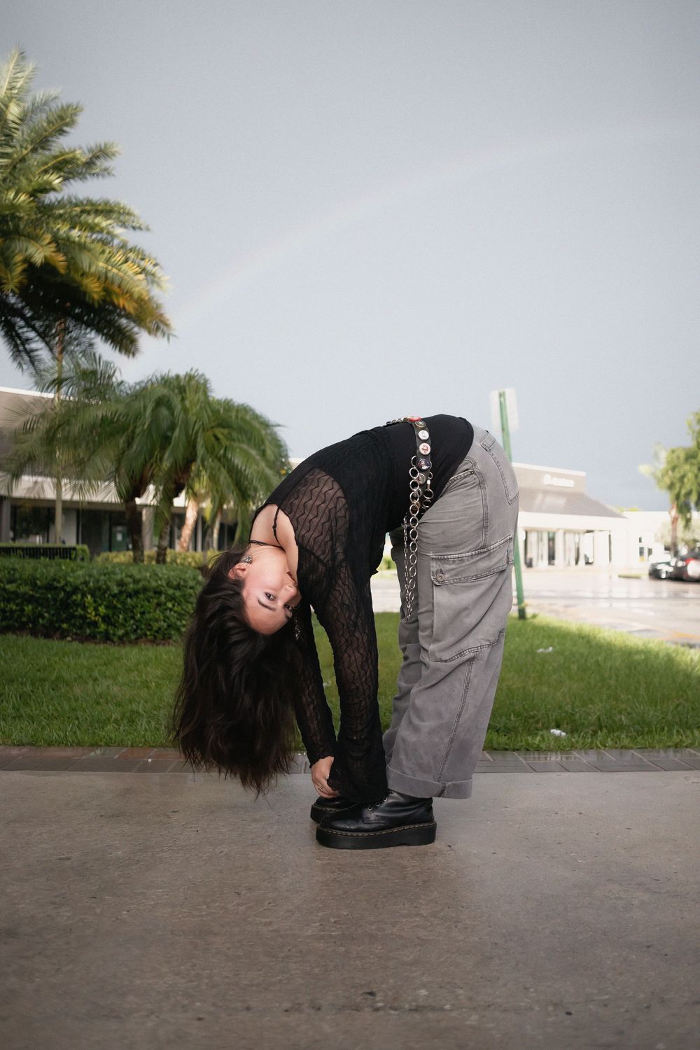 Fashion portrait of woman posing with rainbow at Hammocks Town Center in Miami