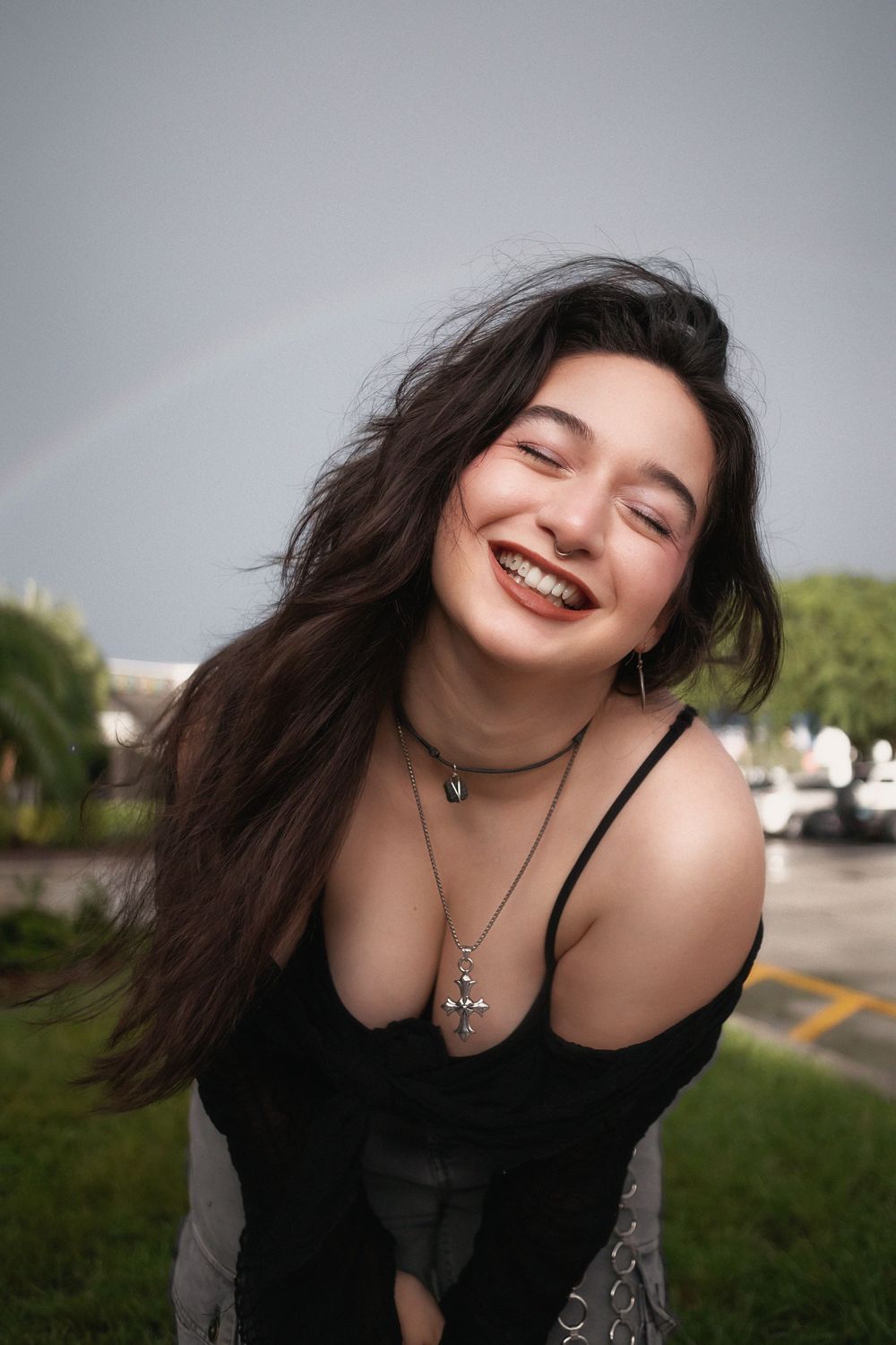 Fashion portrait of woman smiling with rainbow at Hammocks Town Center in Miami