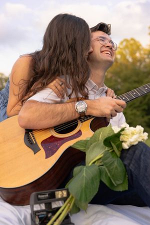 Golden Hour Couples Session at Walnut Creek Park on a blanket with a guitar.