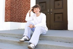 Senior photo in Charlottesville, VA in the city of Charlottesville sitting on stairs.