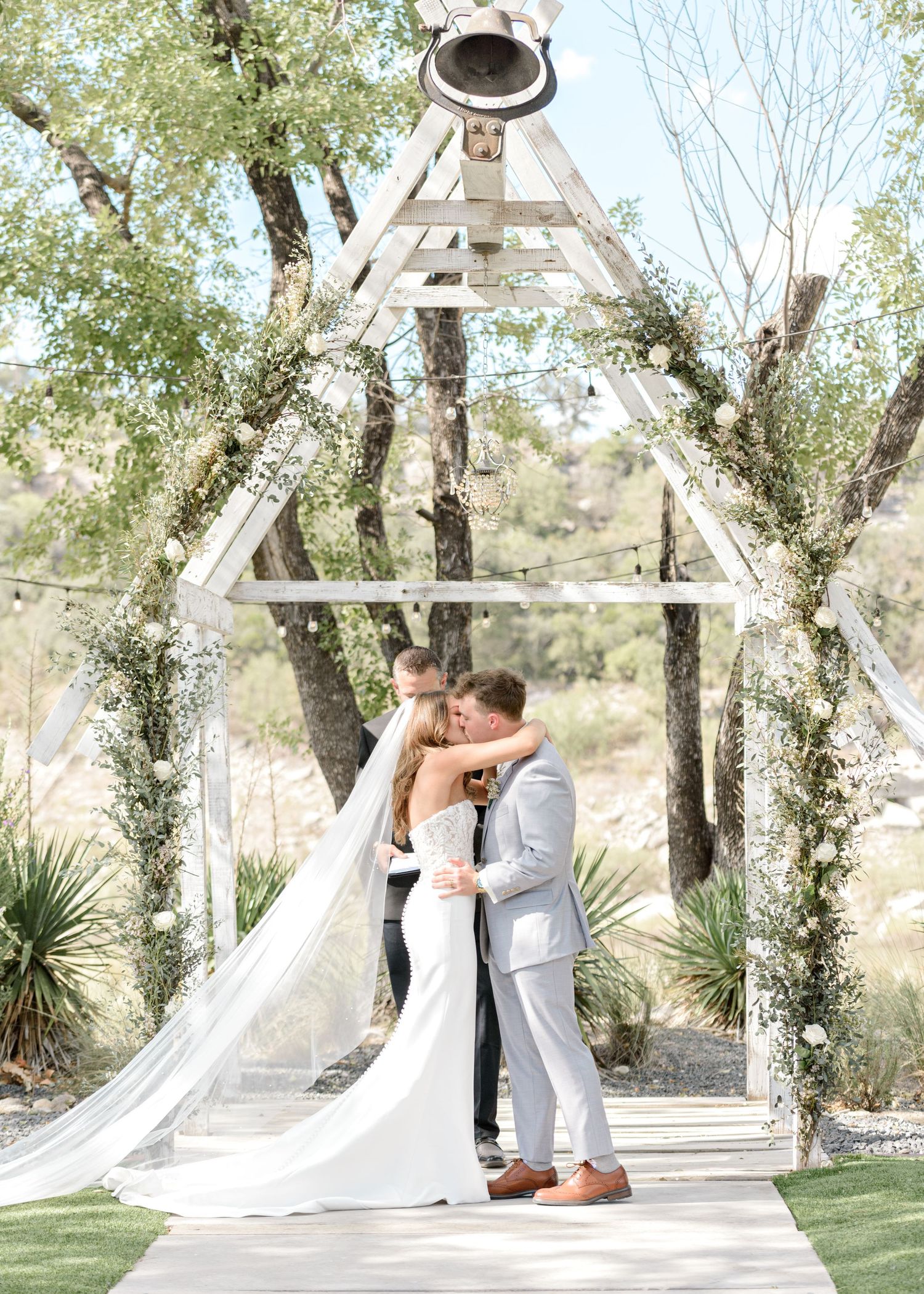 bride and groom sharing their firsrt kiss on their wedding day
