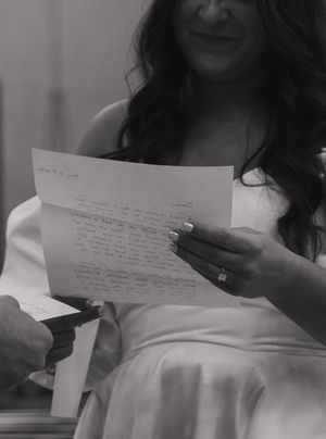 A series of black and white images showing hands holding handwritten letters against a white background.