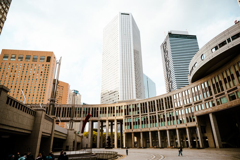 Modern skyscrapers and curved architectural structures at the Tokyo Metropolitan Government Building in Shinjuku, Japan.