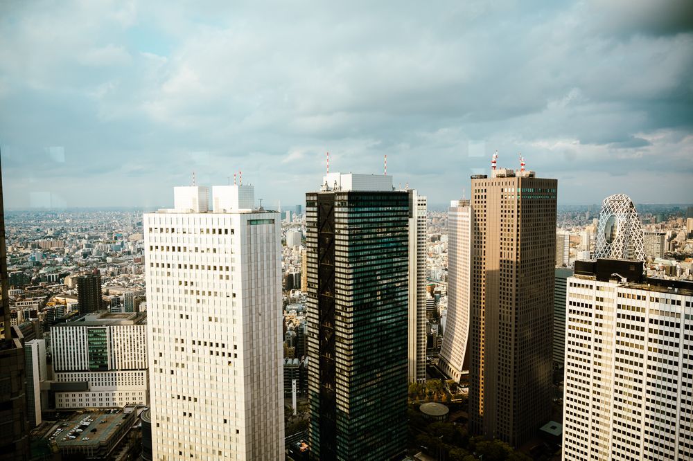 Aerial view of tall modern office buildings and skyscrapers in downtown Sao Paulo, Brazil under cloudy skies.