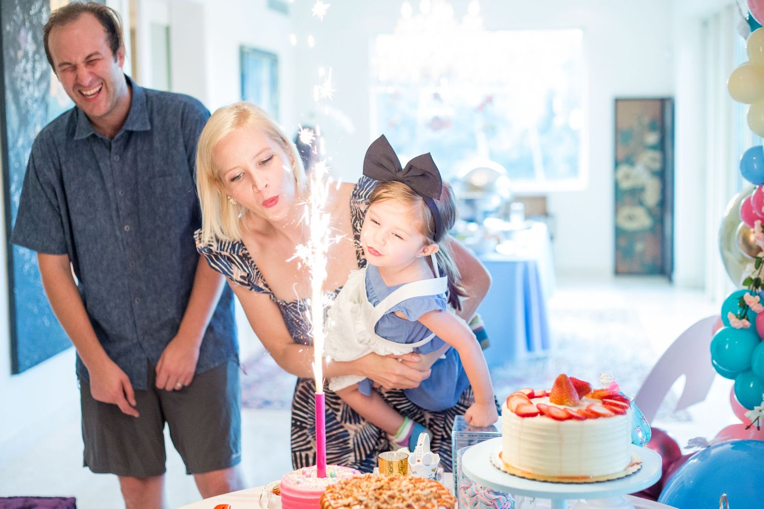 Family photos. Blowing out birthday candle. Kids birthday party in Guaynabo, Puerto Rico.