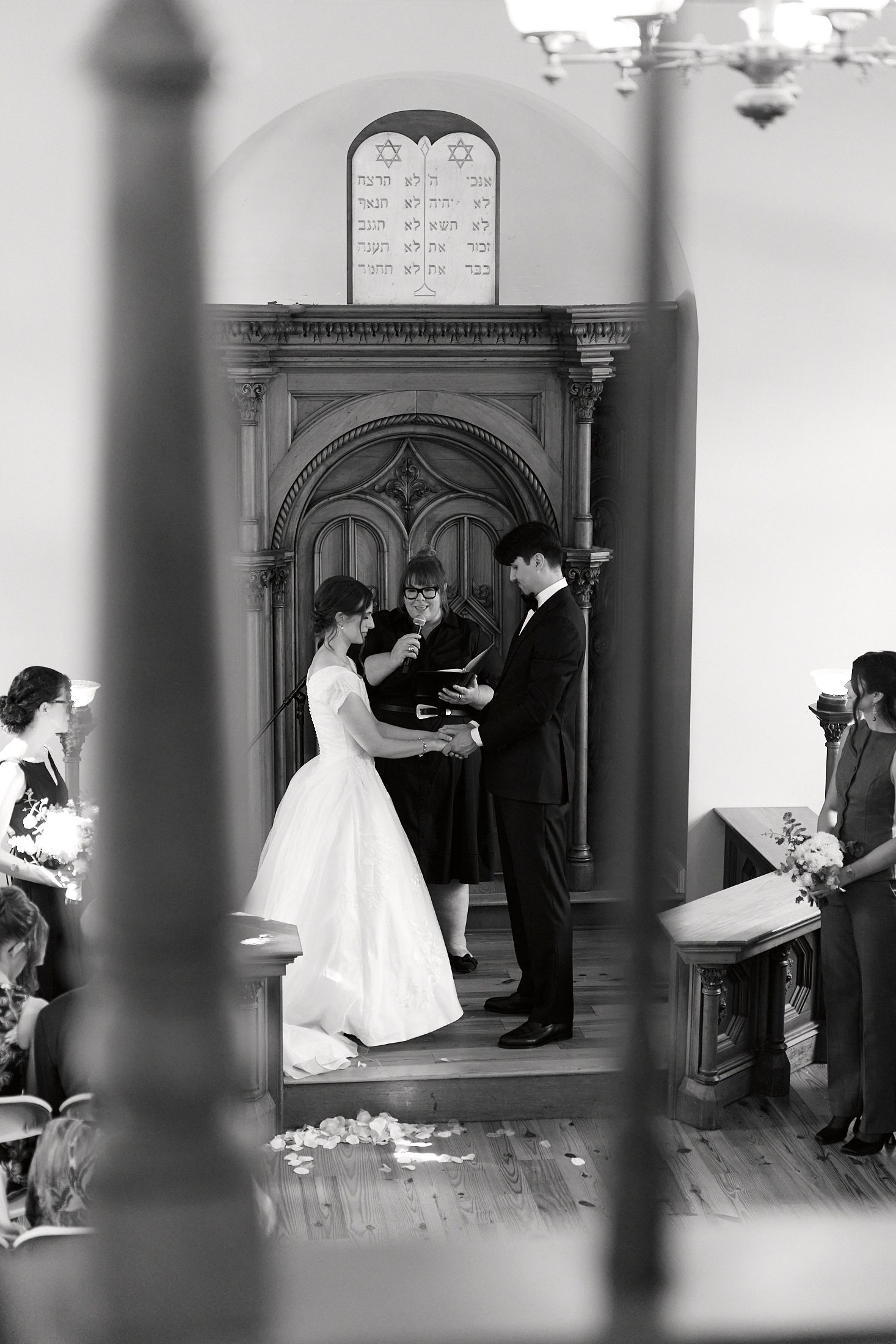 A sequence of black and white photographs showing a wedding ceremony inside a church with couples and guests.
