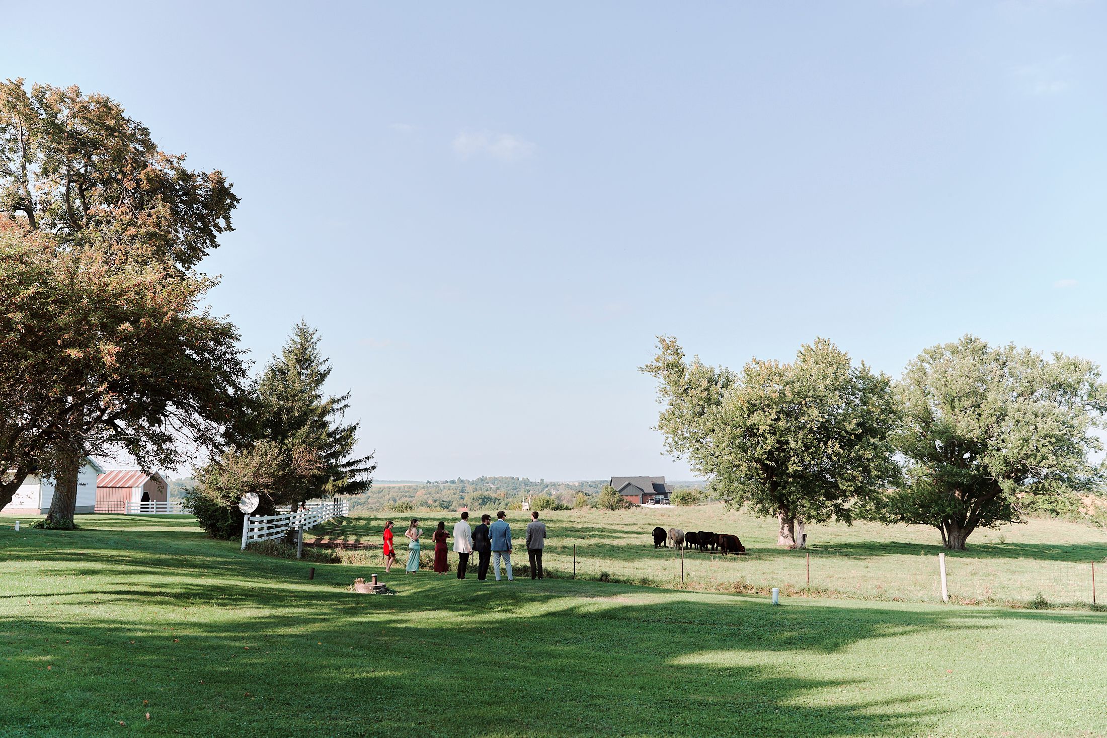 Panoramic view of a countryside wedding venue with rolling hills and trees.