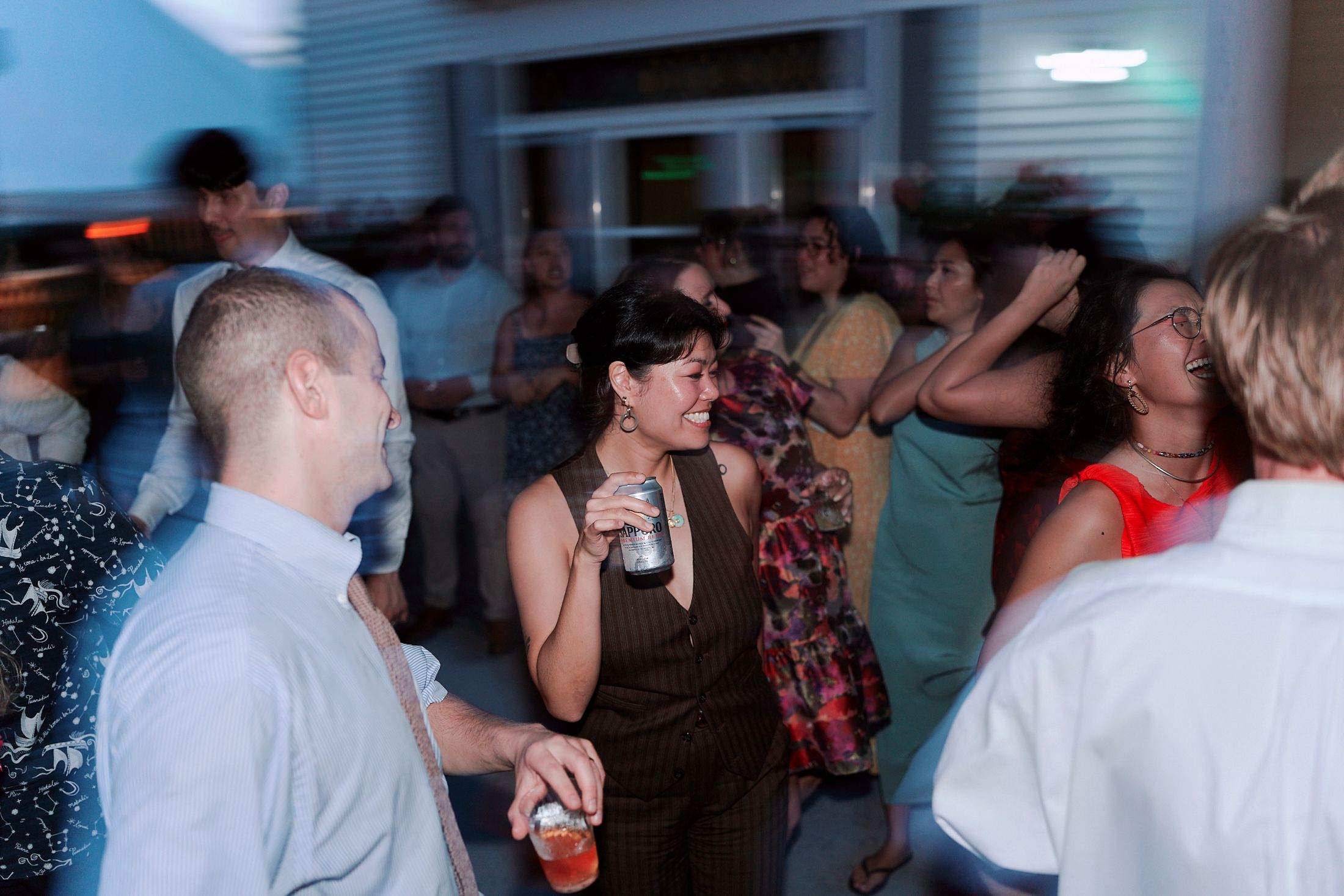 A group of people dancing and socializing at what appears to be a lively indoor party or celebration event.