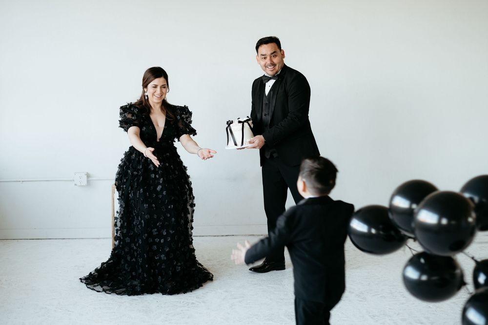 Romantic couple in formal black attire pose together in an intimate photoshoot series.