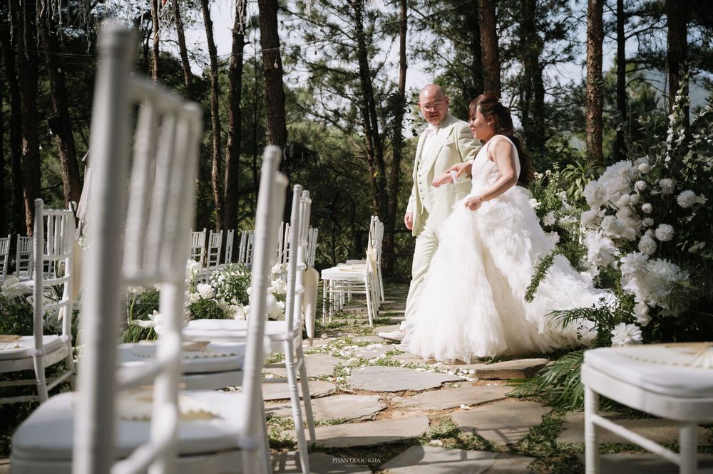 Bride and groom sharing a moment on a stone pathway at an elegant outdoor forest wedding.