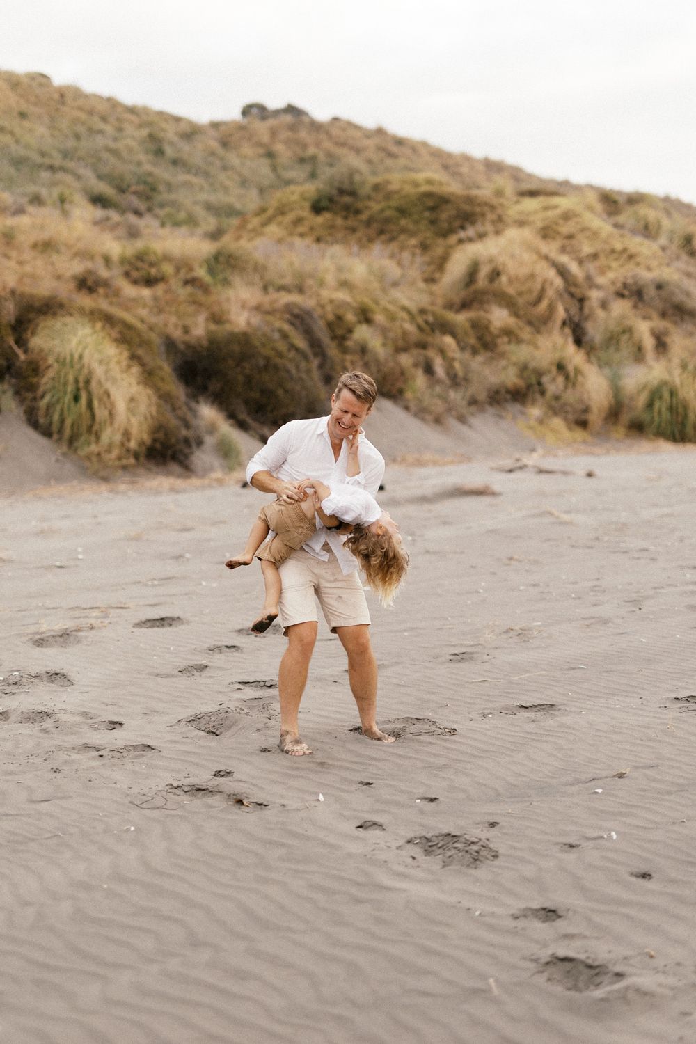 Playful sequence of beach activities against a sandy hillside backdrop.
