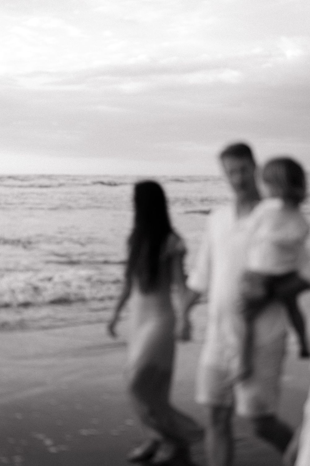 A couple walks together on the beach at sunset, creating a series of silhouetted moments.
