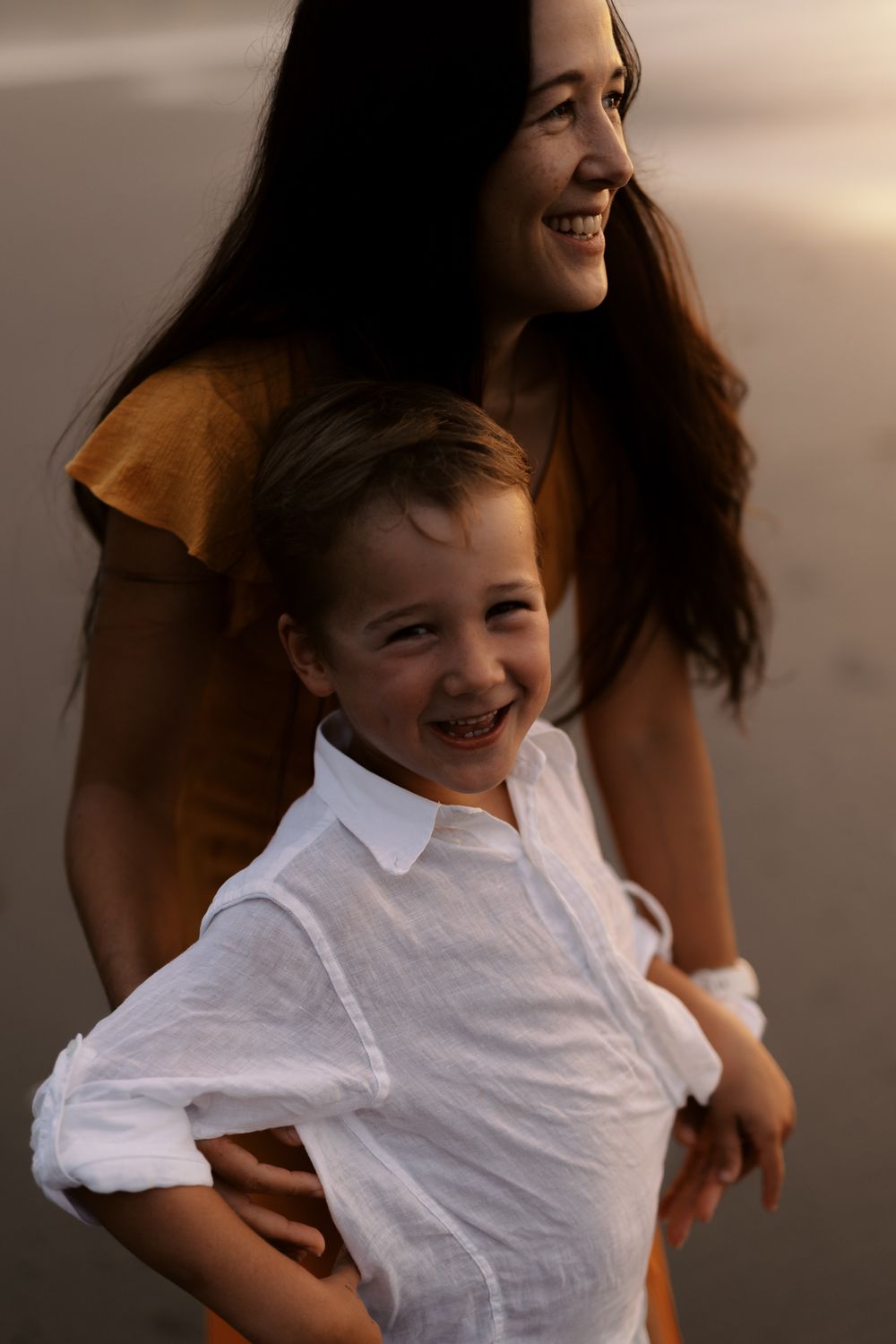 A playful moment featuring a white shirt against a dark background filled with genuine laughter and joy.